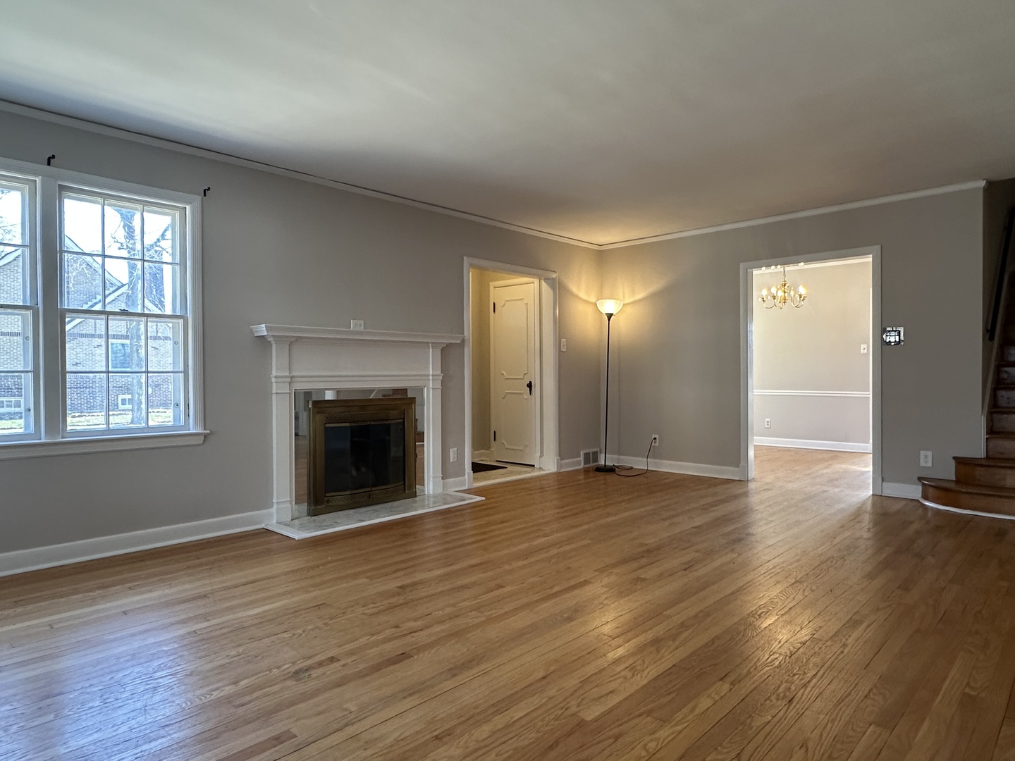 1195 South Myrtle Avenue Kankakee, IL 60901 - Photo 7 of 38 an empty room with wooden floor fireplace and windows