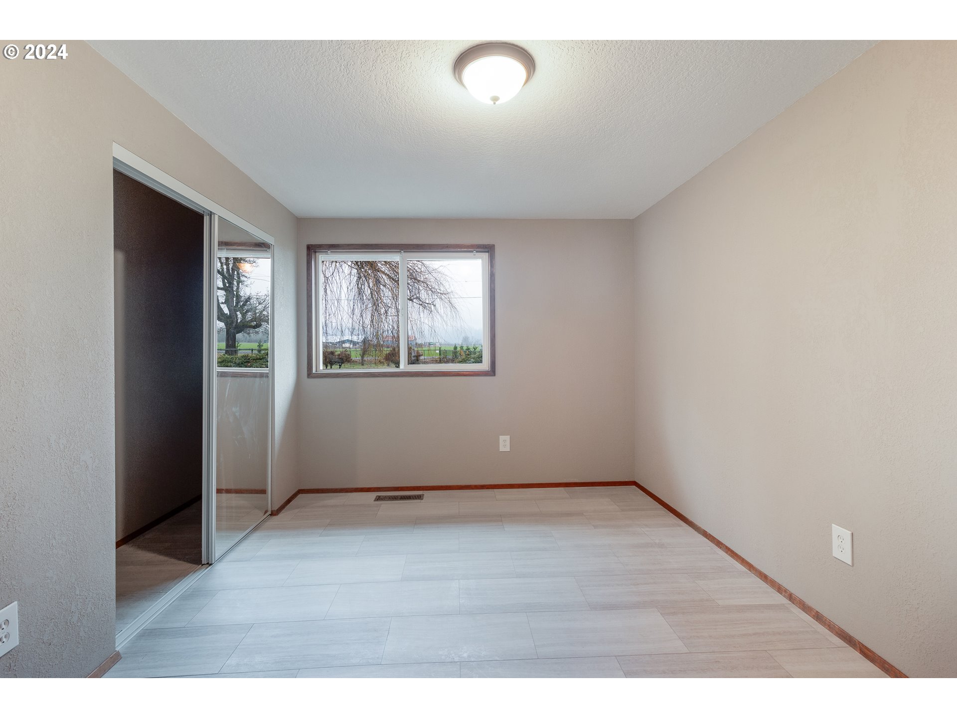 83766 Cloverdale Road Creswell, OR 97426 - Photo 26 of 45 an empty room with wooden floor and windows
