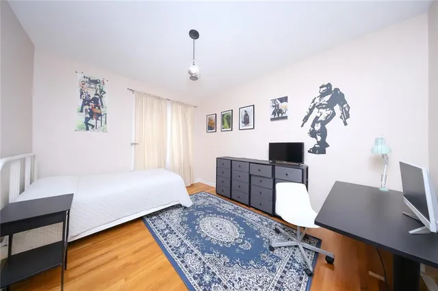 a bedroom with a bed and a desk