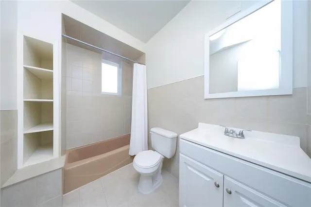 a white toilet sitting next to a bathroom sink