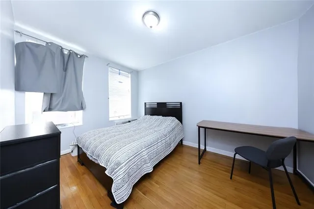 a bedroom with a bed and a desk