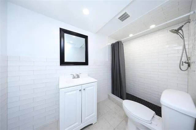 a bathroom with a toilet sink and shower