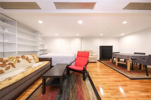 a living room with furniture a rug and a table