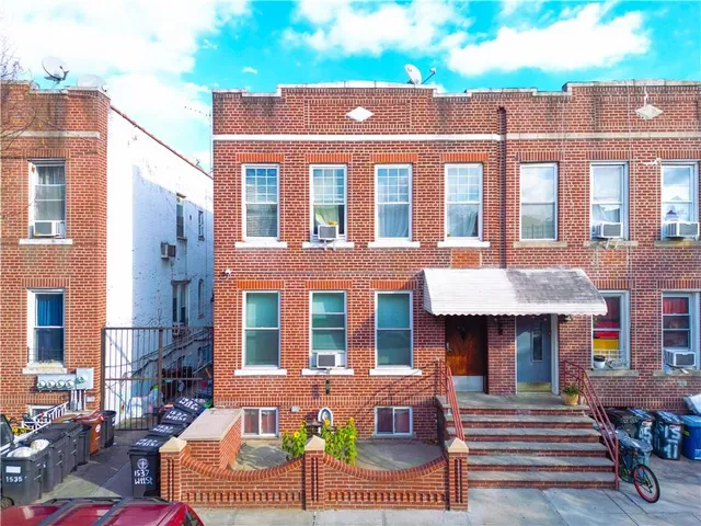 a front view of a house with outdoor seating