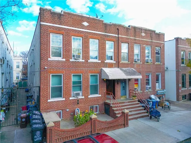 a front view of a building with outdoor seating