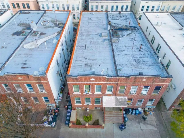 a view of a brick building with many windows