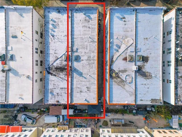 an aerial view of multi story residential apartment building with outdoor space