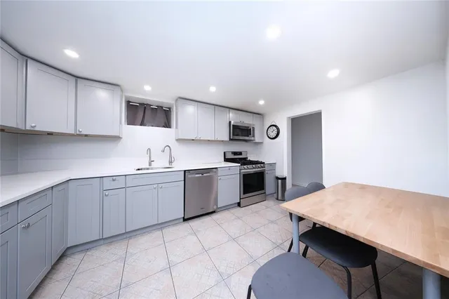 a kitchen with a sink a microwave and refrigerator