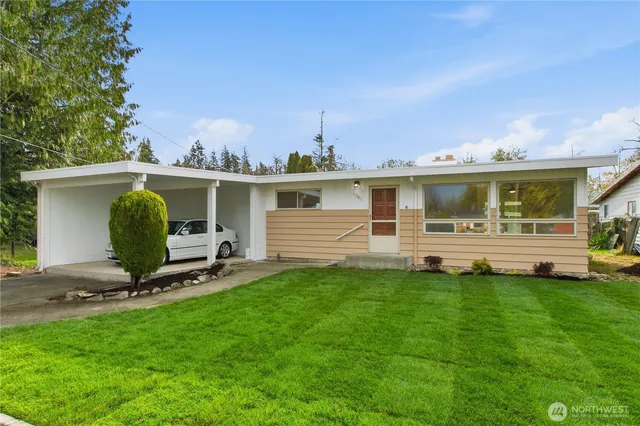a view of a house with backyard sitting area and garden