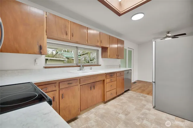 a kitchen with granite countertop a sink and cabinets