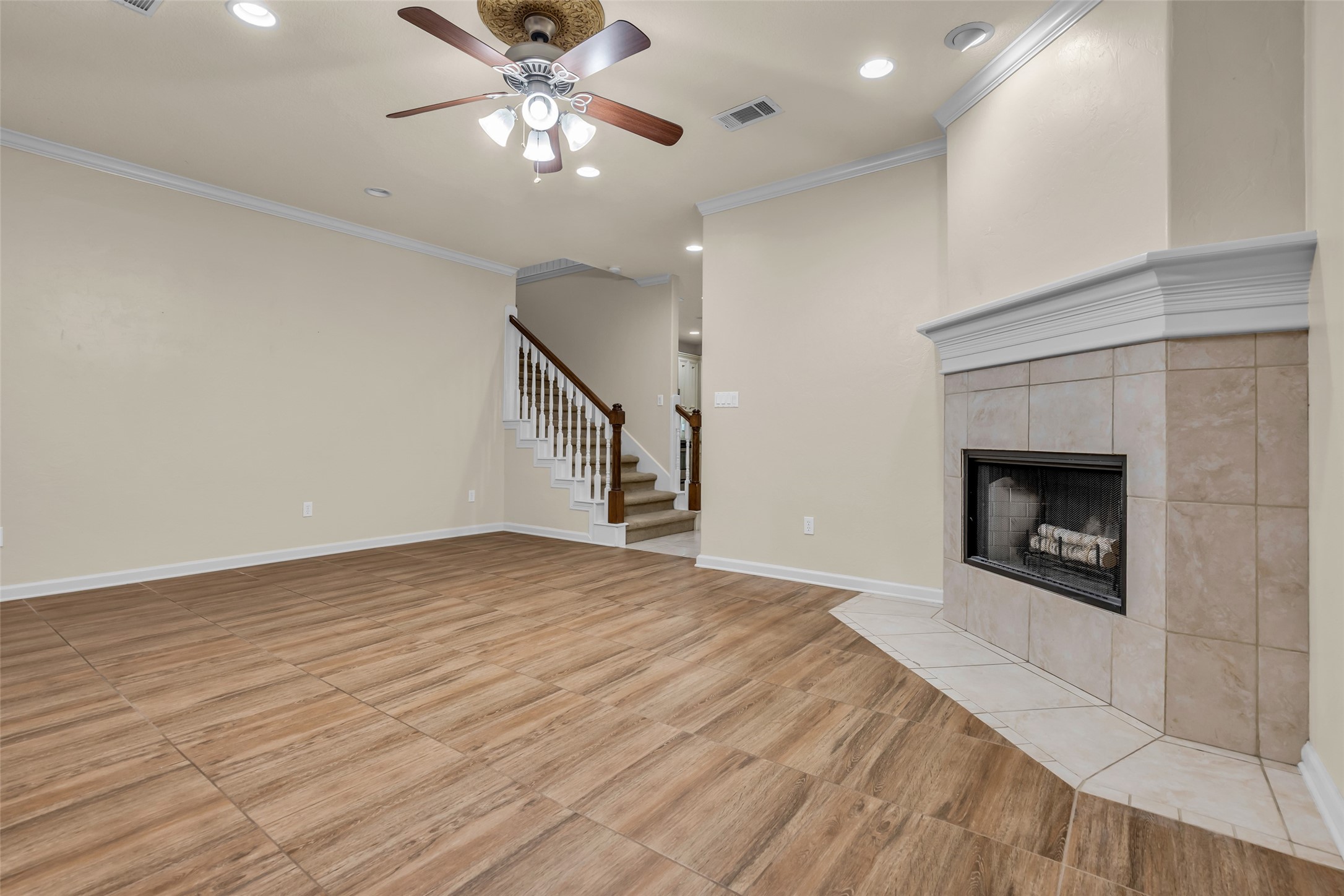 1898 Longmire Road, Unit 5 Conroe, TX 77304 - Photo 14 of 48 a view of an empty room with chandelier fan and fire place