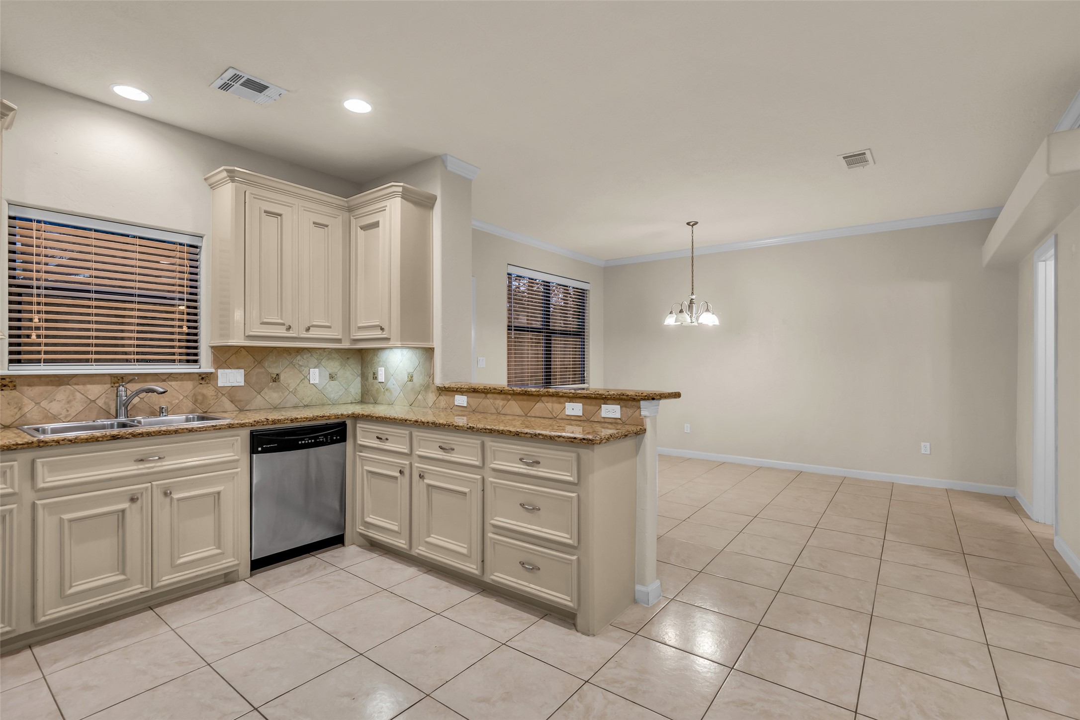 1898 Longmire Road, Unit 5 Conroe, TX 77304 - Photo 18 of 48 a kitchen with white cabinets a sink and appliances