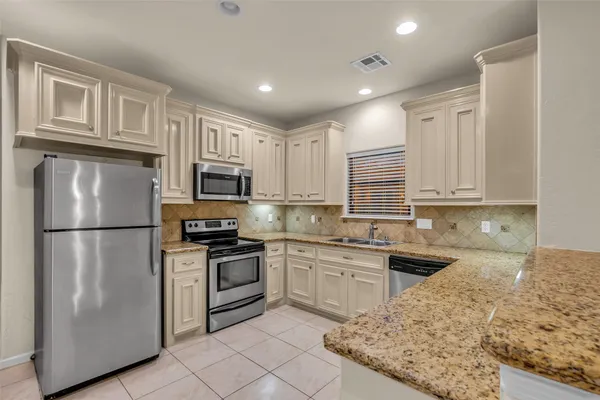 a view of a storage and utility room with washer and dryer
