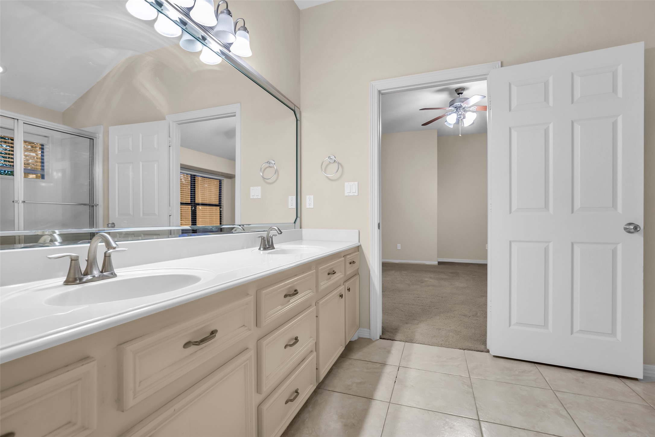 1898 Longmire Road, Unit 5 Conroe, TX 77304 - Photo 34 of 48 a spacious bathroom with a double vanity sink a mirror and a shower