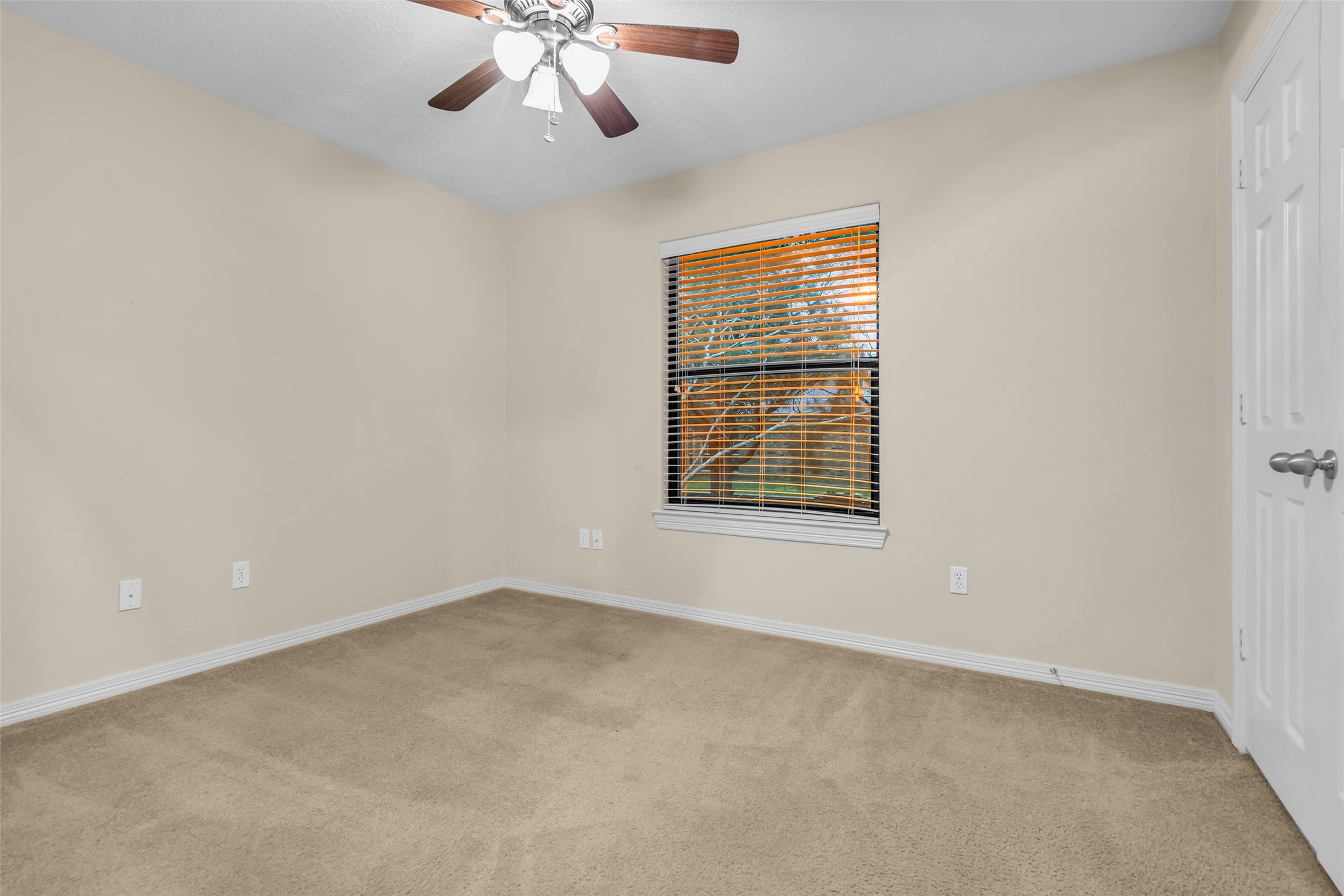1898 Longmire Road, Unit 5 Conroe, TX 77304 - Photo 36 of 48 an empty room with a chandelier fan and windows