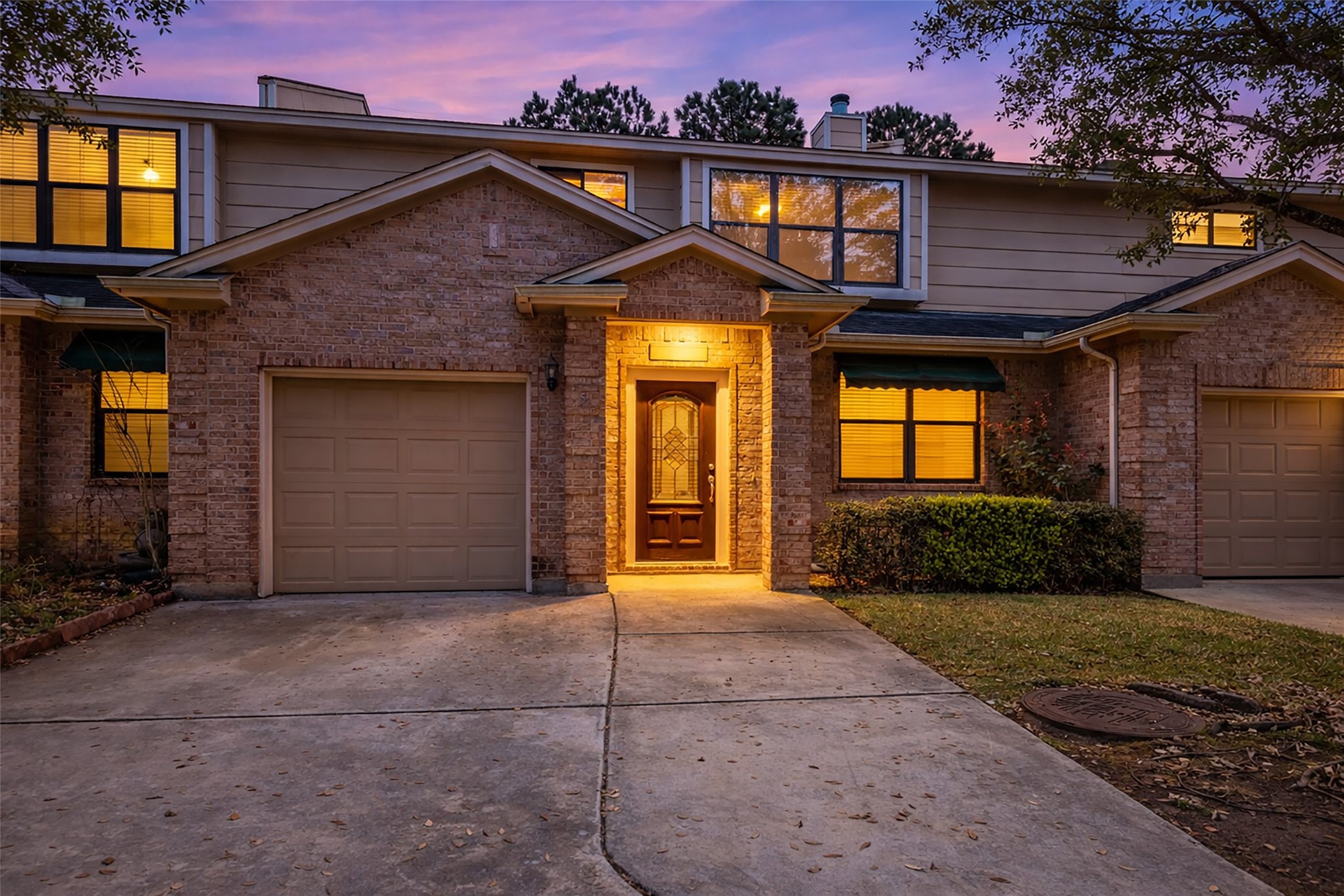 1898 Longmire Road, Unit 5 Conroe, TX 77304 - Photo 41 of 48 Charming two-story townhouse with a welcoming front entrance, garage, and well-maintained exterior. Warm lighting and a peaceful neighborhood setting enhance its curb appeal. Perfect for comfortable living.