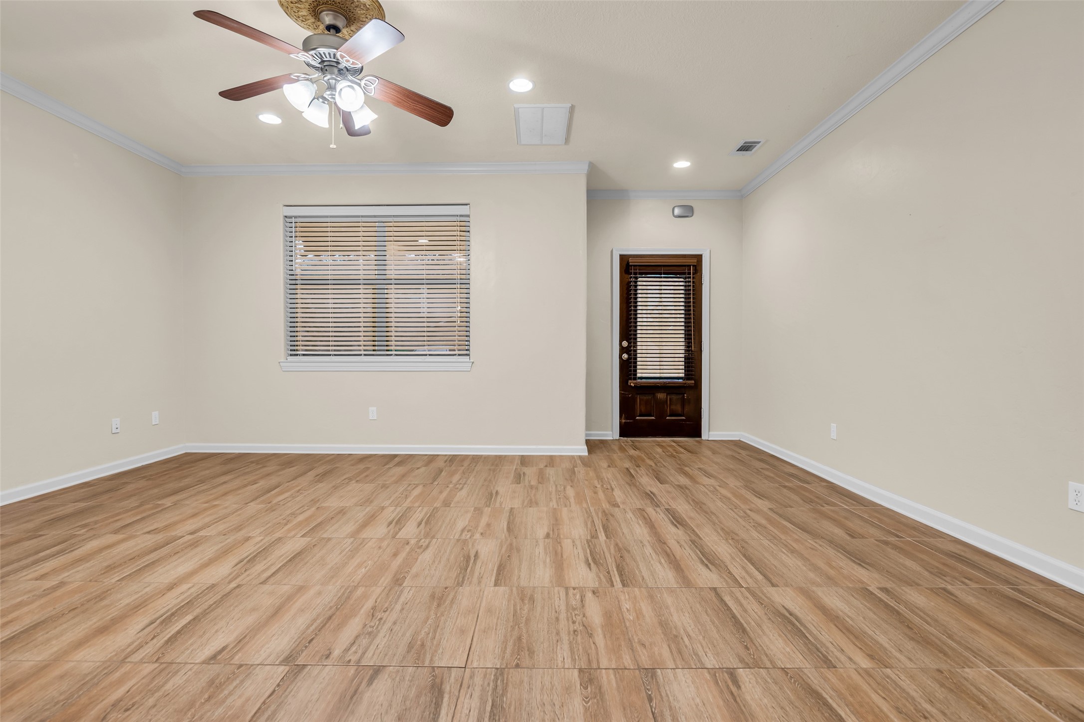 1898 Longmire Road, Unit 5 Conroe, TX 77304 - Photo 10 of 48 a view of an empty room with wooden floor and a window