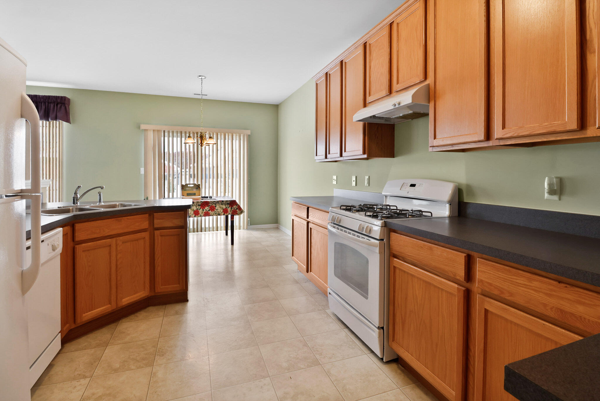 11732 Virginia Court Crown Point, IN 46307 - Photo 11 of 26 a kitchen with stainless steel appliances granite countertop a stove a sink and a microwave