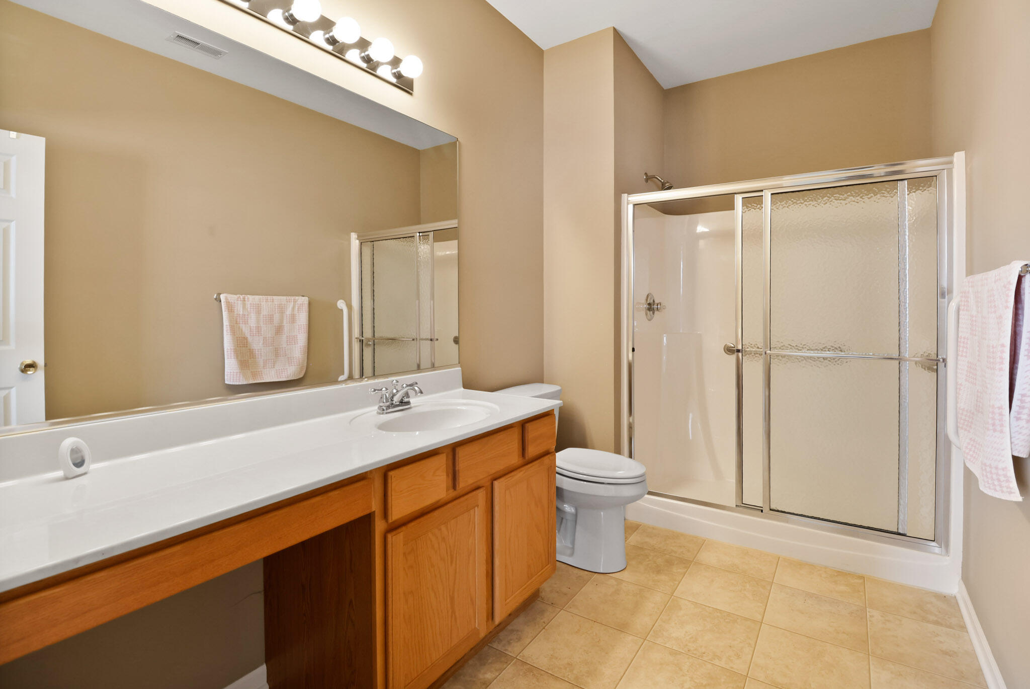 11732 Virginia Court Crown Point, IN 46307 - Photo 16 of 26 a bathroom with a sink toilet and shower
