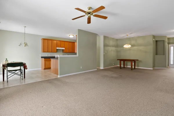 a view of a livingroom with a table and chairs