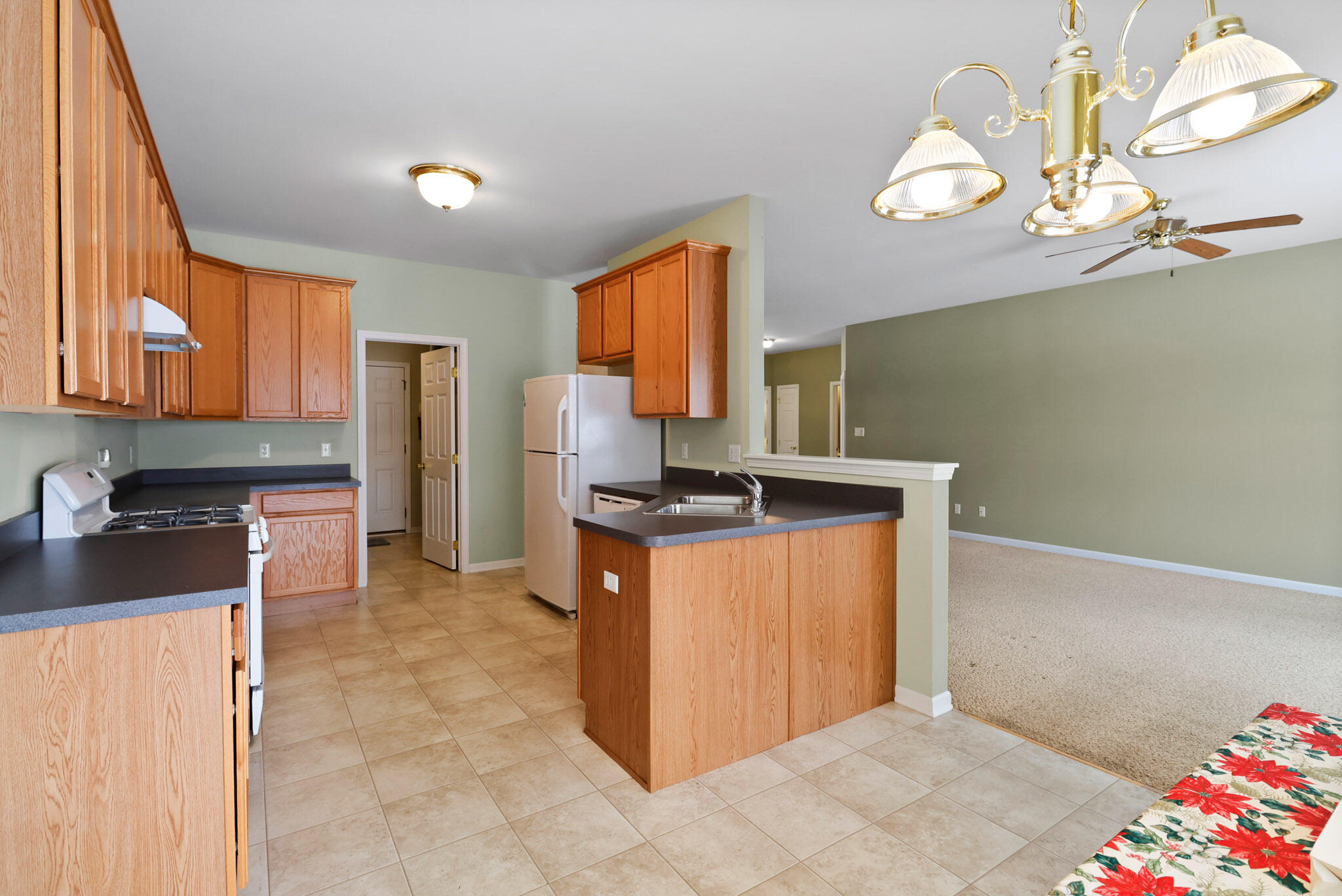 11732 Virginia Court Crown Point, IN 46307 - Photo 9 of 26 a kitchen with stainless steel appliances granite countertop a sink stove and refrigerator