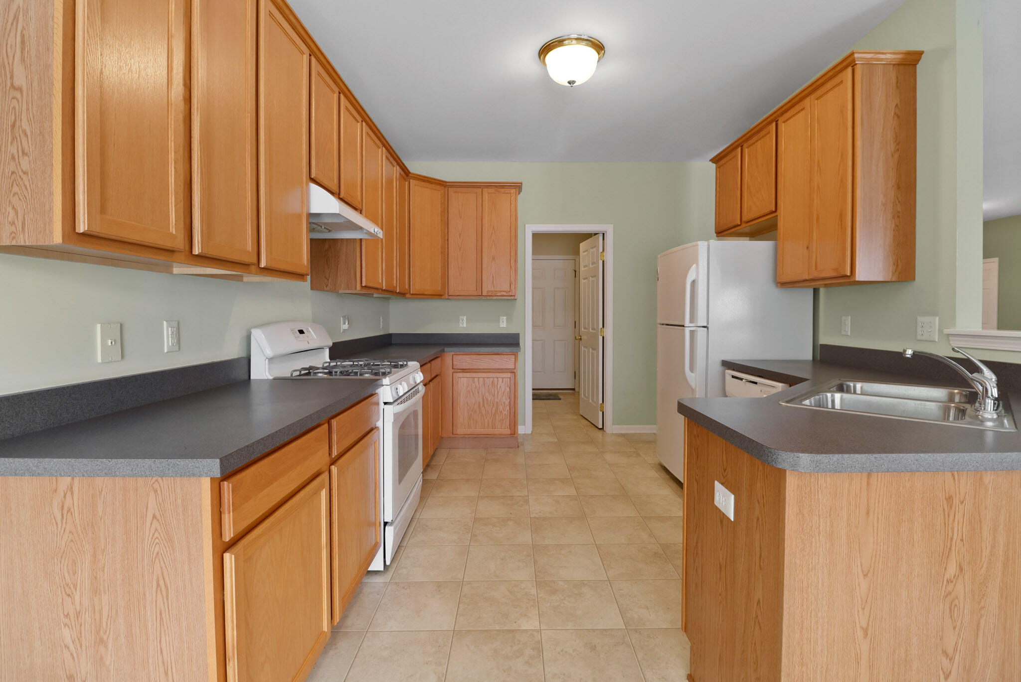 11732 Virginia Court Crown Point, IN 46307 - Photo 10 of 26 a kitchen with stainless steel appliances granite countertop a sink stove and refrigerator