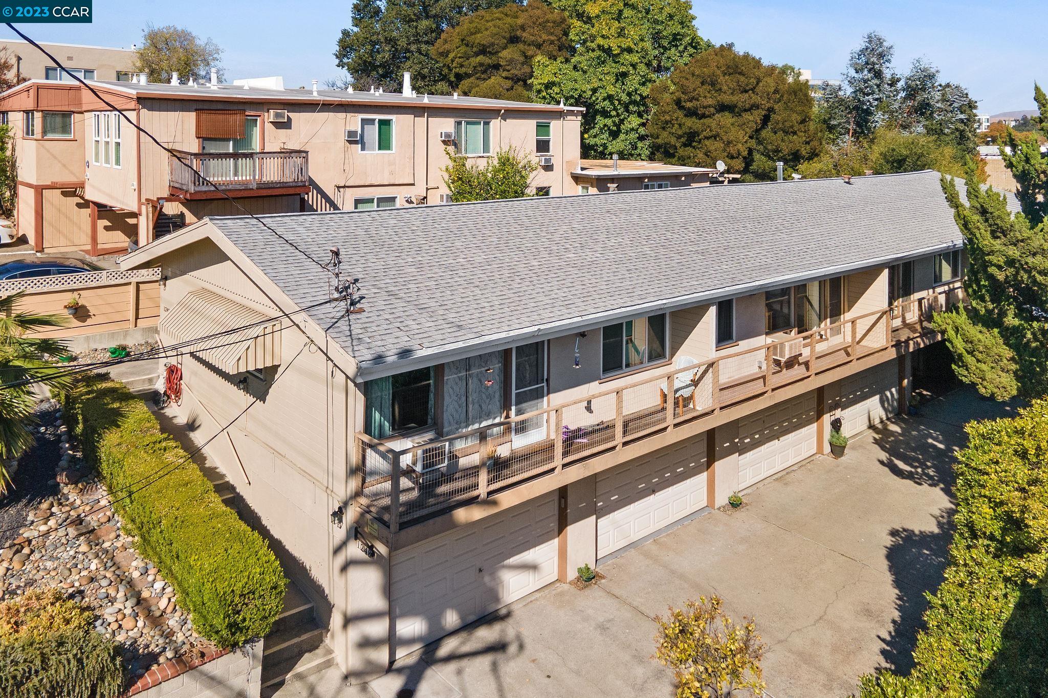 an aerial view of a house with wooden deck