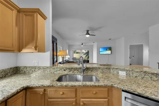 a kitchen with granite countertop a sink and cabinets