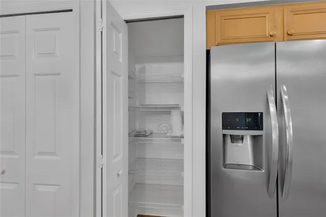 a bathroom with a refrigerator and a sink