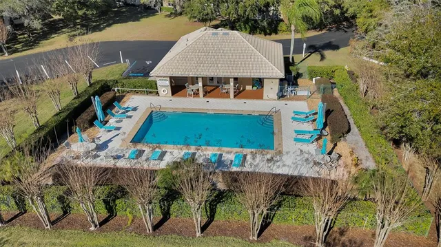 an aerial view of a house with swimming pool and patio