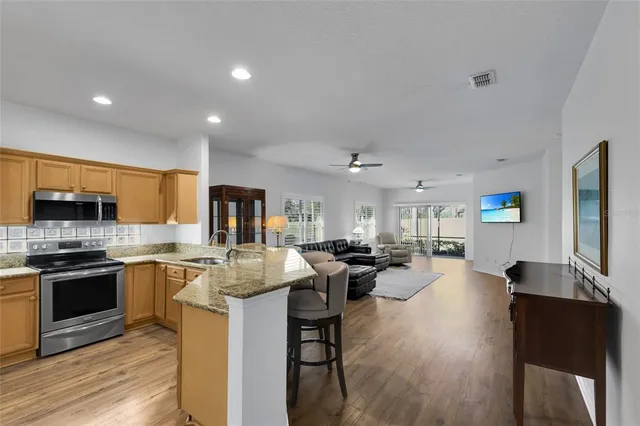 a kitchen with sink stove and cabinets