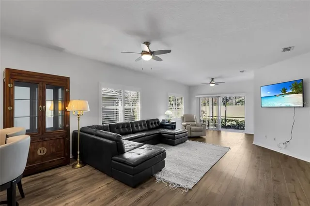a living room with furniture fireplace and a large window