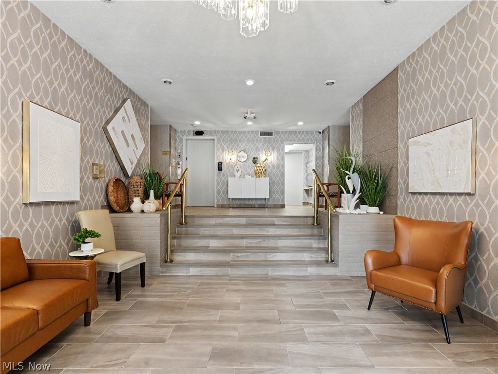 3064 Kent Road Stow, OH 44224 - Photo 25 of 30 Patterned wallcovering accenting the space, contemporary chandelier, recessed lighting, and tile flooring