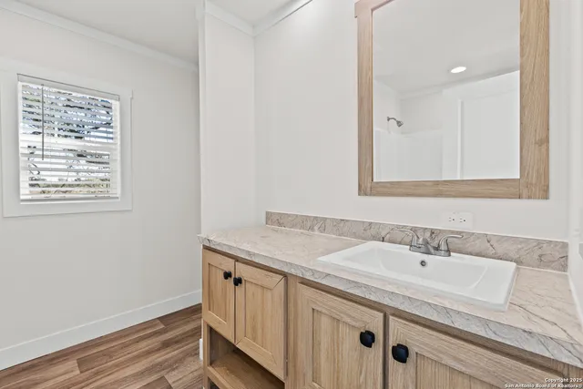 a bathroom with a sink a vanity and a mirror