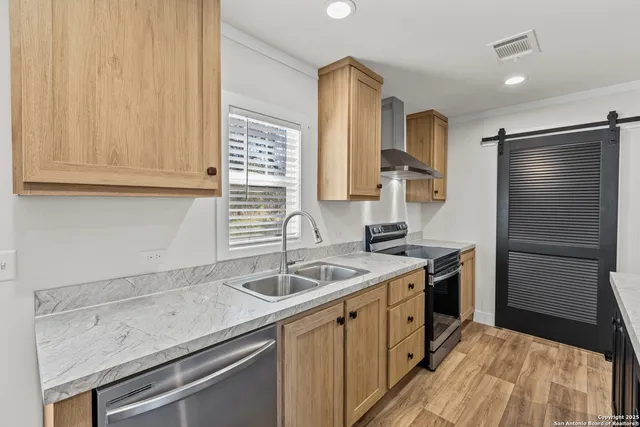 a kitchen with a sink stove and refrigerator