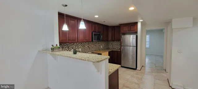 a kitchen with a refrigerator and a sink