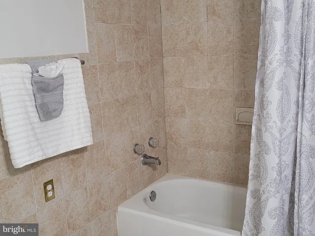 a bathroom with a shower curtain and a sink