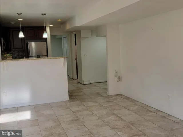 a view of a hallway with a refrigerator