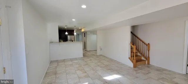 a view of a hallway to rooms and stairs