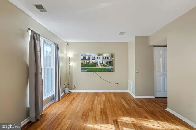 a view of a room with wooden floor and window