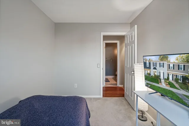 a view of hallway with livingroom and stairs