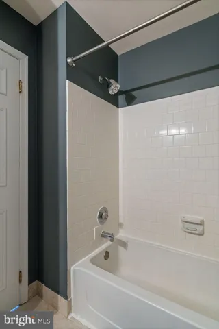 a bathroom with a bathtub and shower