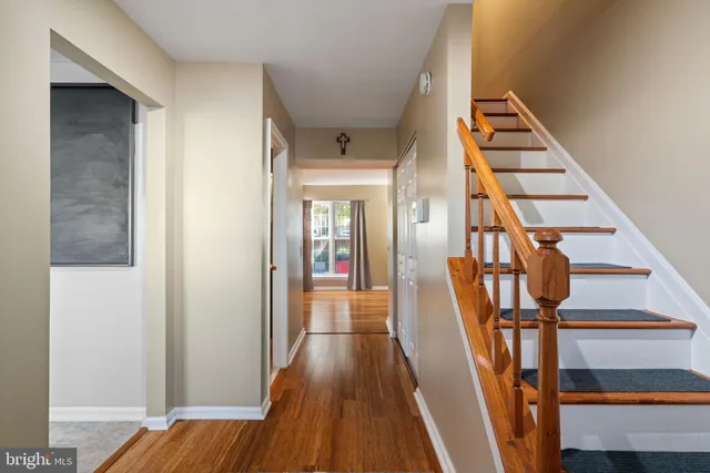 a view of a hallway with wooden floor and entryway