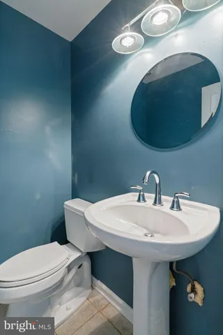 a bathroom with a sink a toilet and mirror
