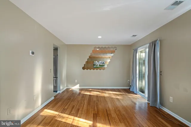 a view of a room with wooden floor and natural light