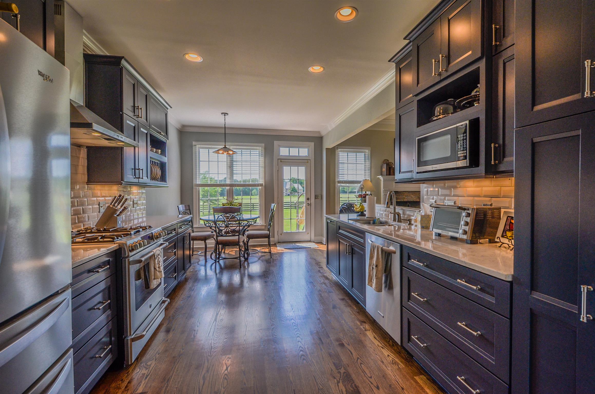 4097 Trinity Road Franklin, TN 37067 - Photo 14 of 30 a large kitchen with stainless steel appliances granite countertop lots of counter space and wooden floors
