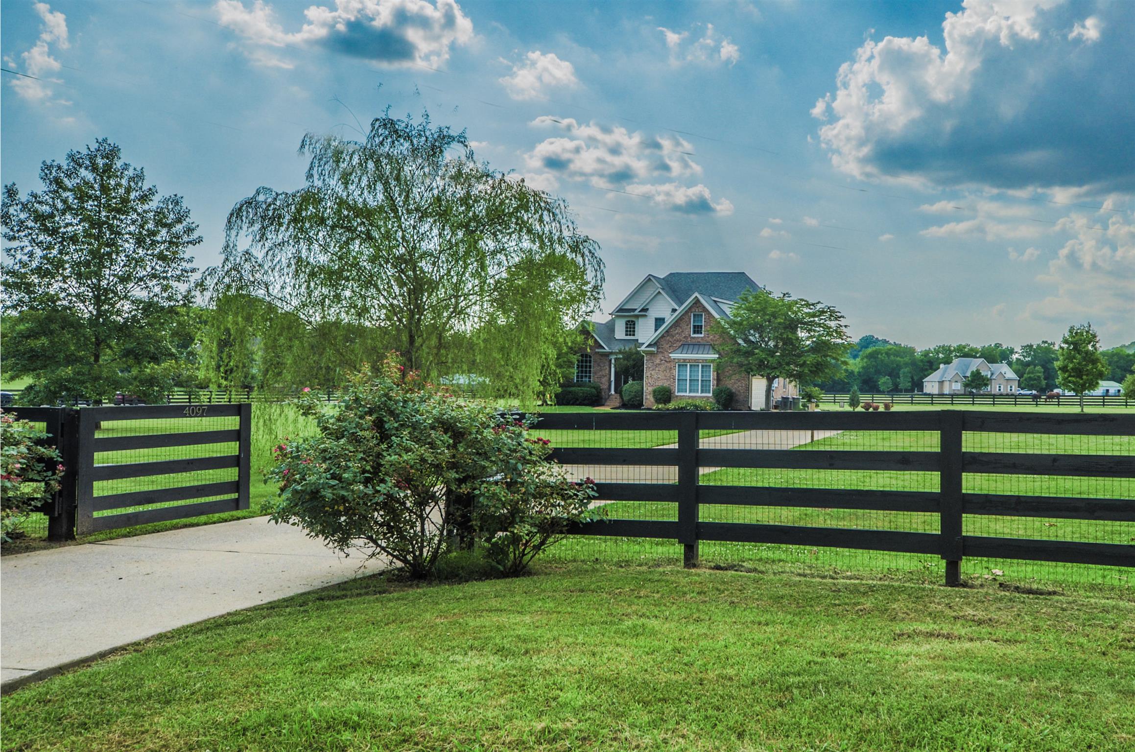 4097 Trinity Road Franklin, TN 37067 - Photo 2 of 30 a view of a garden with a bench in the background