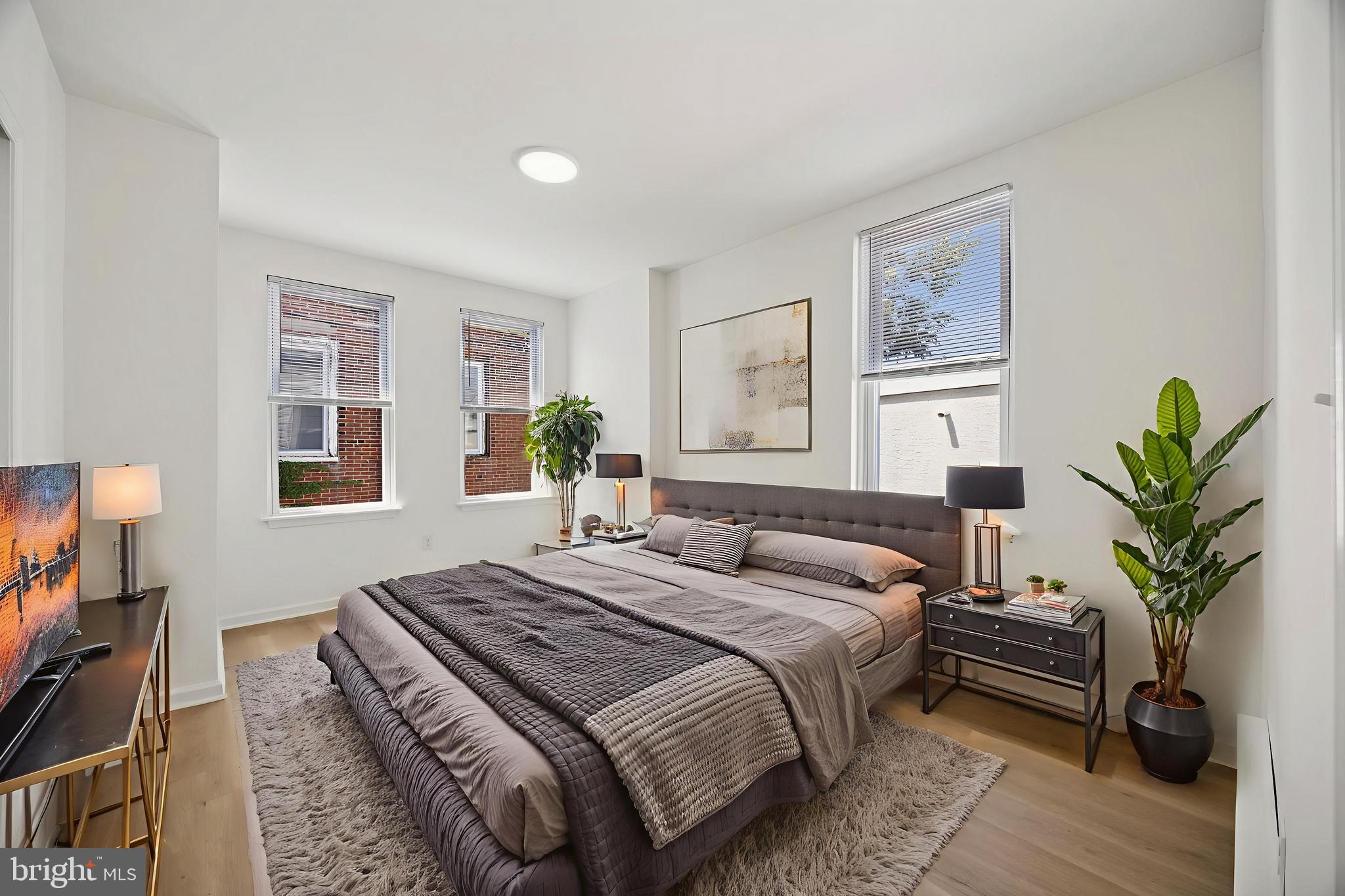 278 South 60th Street Philadelphia, PA 19139 - Photo 11 of 20 a bedroom with a bed a potted plant and a window