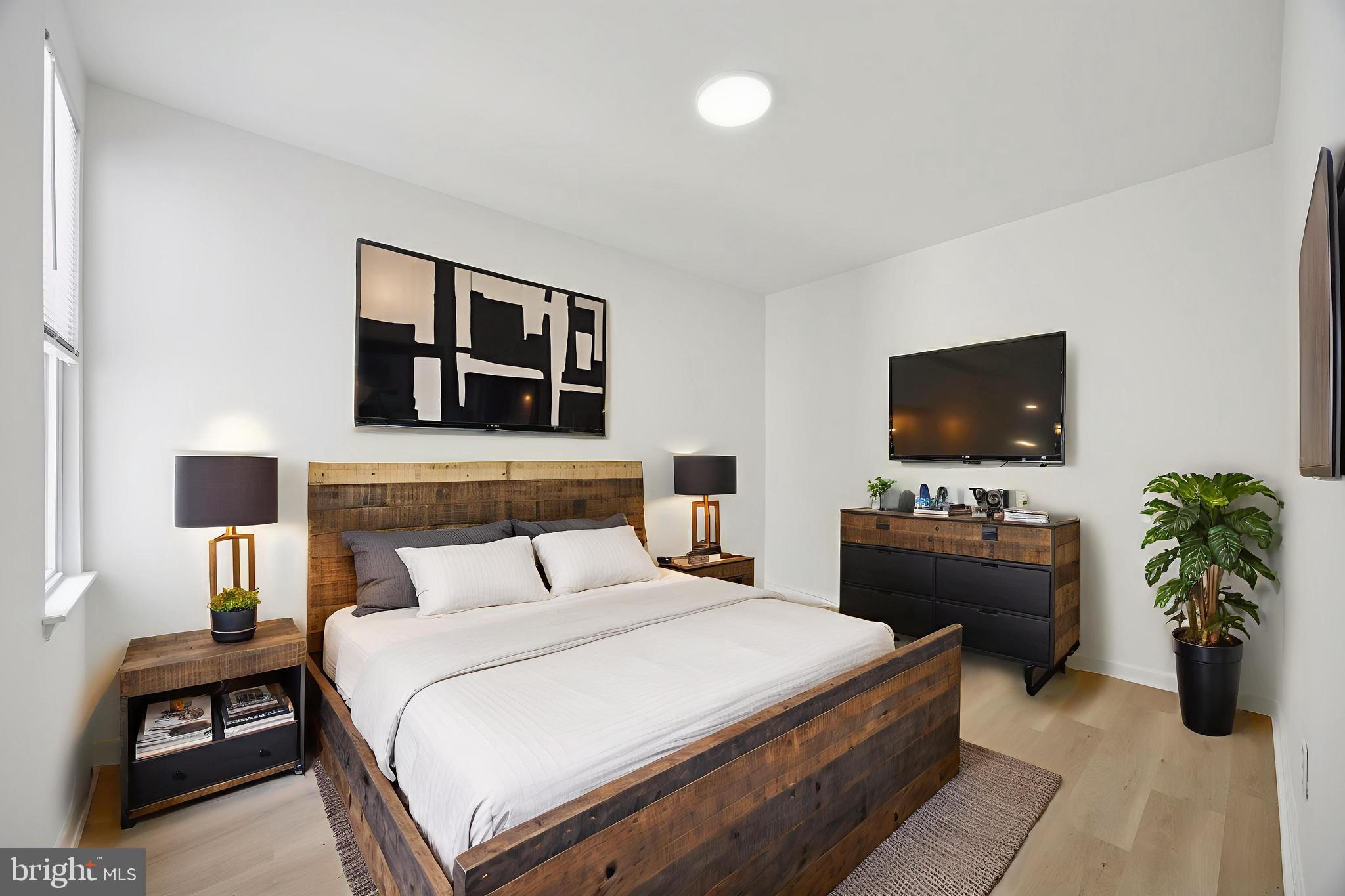 278 South 60th Street Philadelphia, PA 19139 - Photo 16 of 20 a bedroom with a bed and a flat screen tv