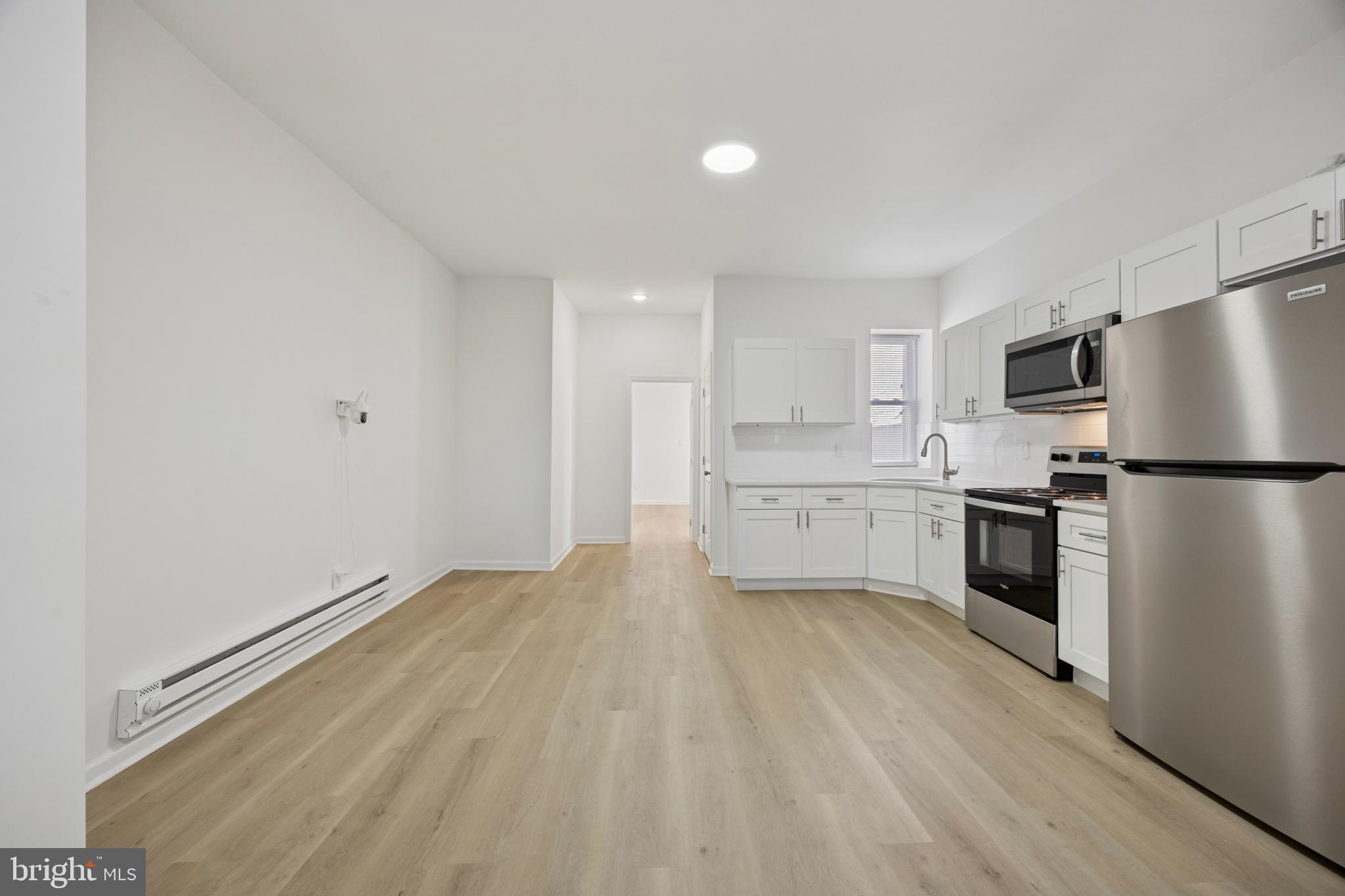 278 South 60th Street Philadelphia, PA 19139 - Photo 5 of 20 a kitchen with stainless steel appliances a refrigerator sink and cabinets